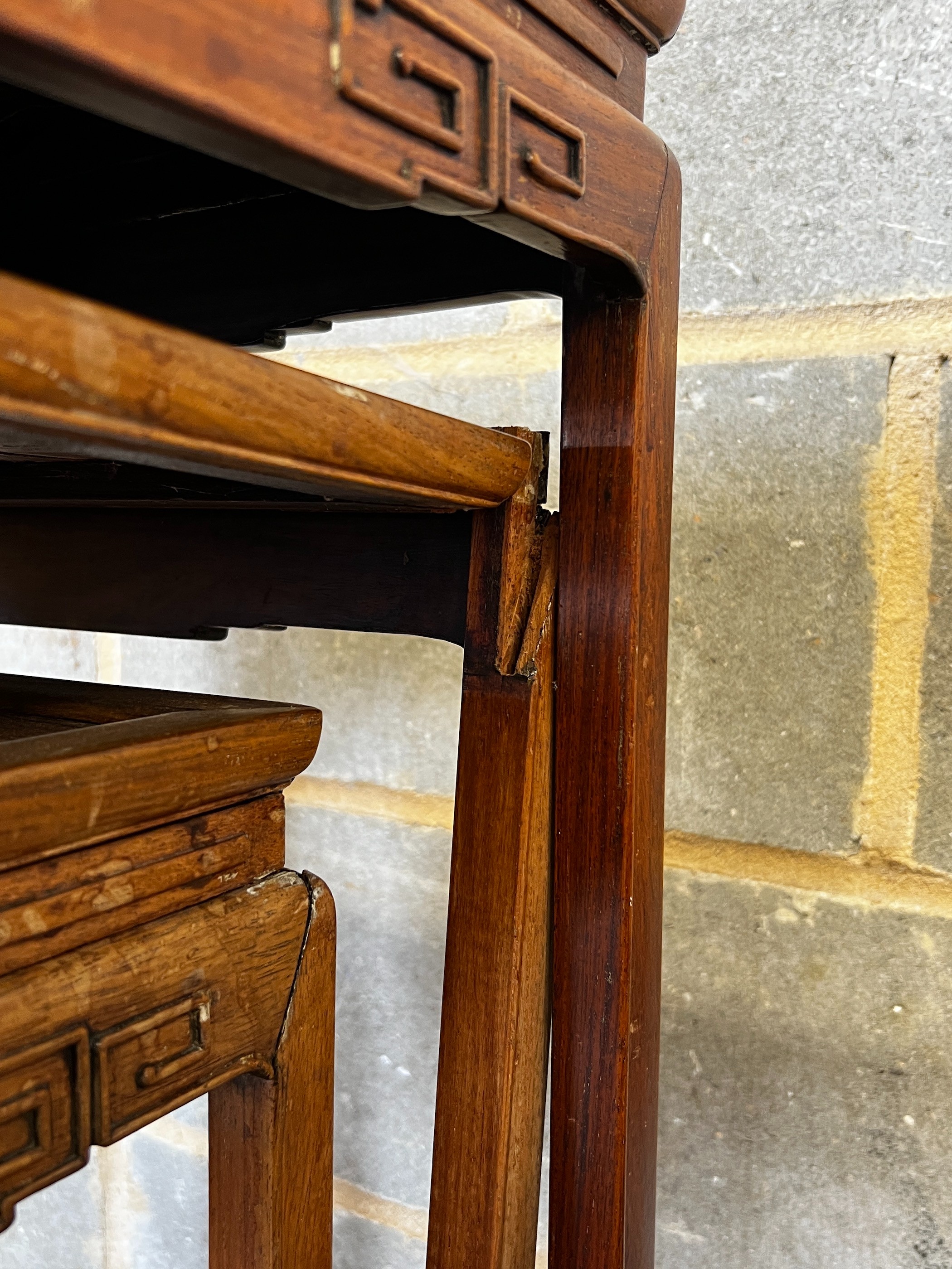 A nest of three Chinese rectangular hardwood tea tables, width 49cm, depth 35cm, height 59cm